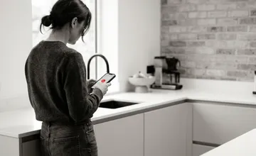 Homeowner in Tampa Bay searching on mobile phone for a local contractor